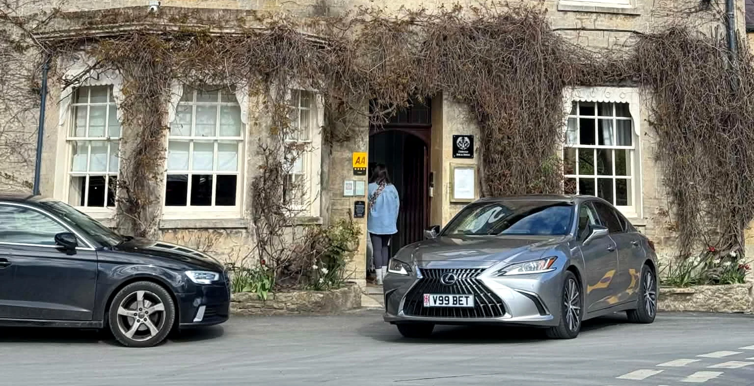 Beyond Elite Travel Lexus ES, plate V99 BET, outside a stone inn in Bibury in the Cotswolds