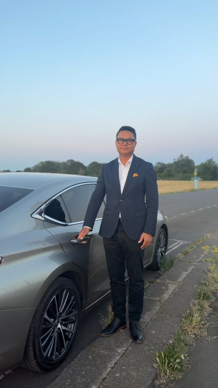 Som Roscoe, founder of Beyond Elite Travel, beside the Lexus ES 300h